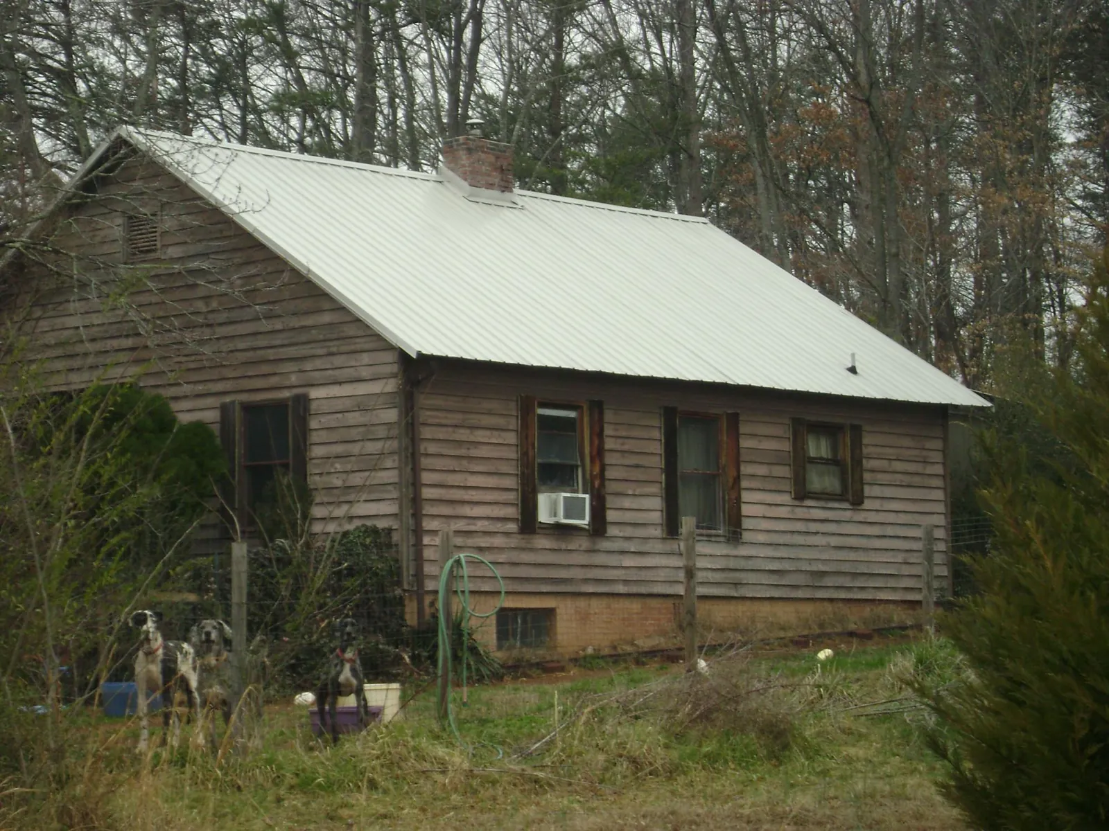White metal roof on an old wood sided farmhouse, from a Metal Roof Installation job in Loysburg